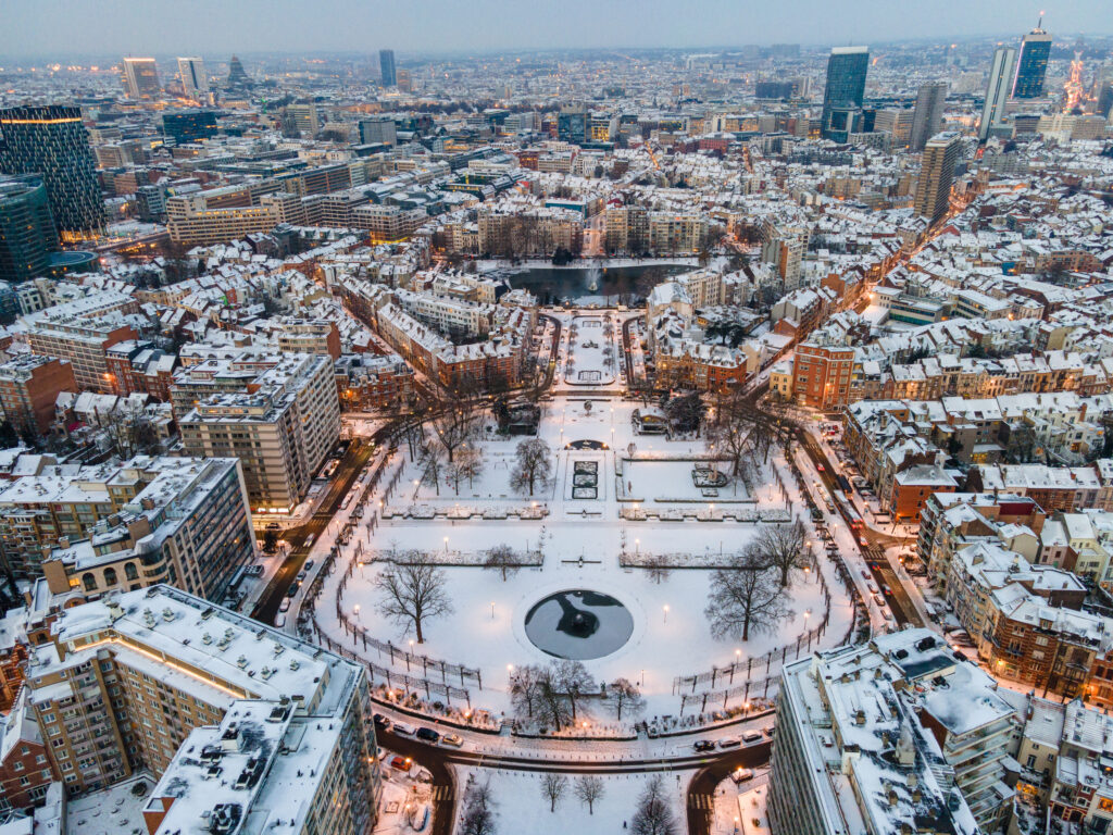Aerial view of a snow covered Ambiorix Park in Central Brussels on a winter morning with street lights