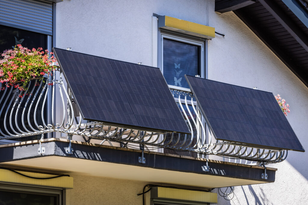 Balcony solar power plant. Solar battery on balcony wall. Mini PV plants generate your own electricity plug play