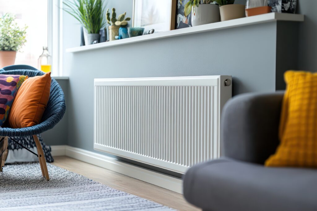 Modern white radiator against a home wall, symbolizing heating, comfort, interior design, and energy efficiency during cold seasons.