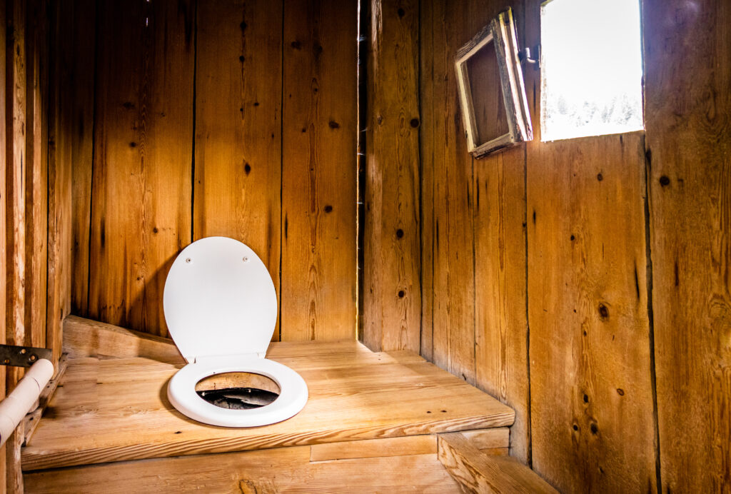 indoors an old wooden outhouse