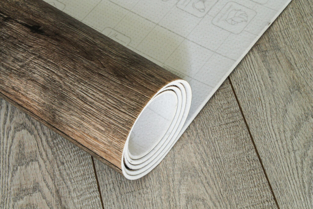 Roll of linoleum with a wood texture. Types of floor coverings. PVC.