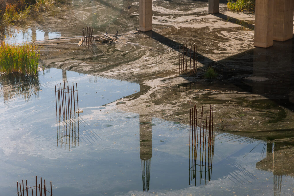 Flooded foundation construction site after hurricane in concrete footing foundation