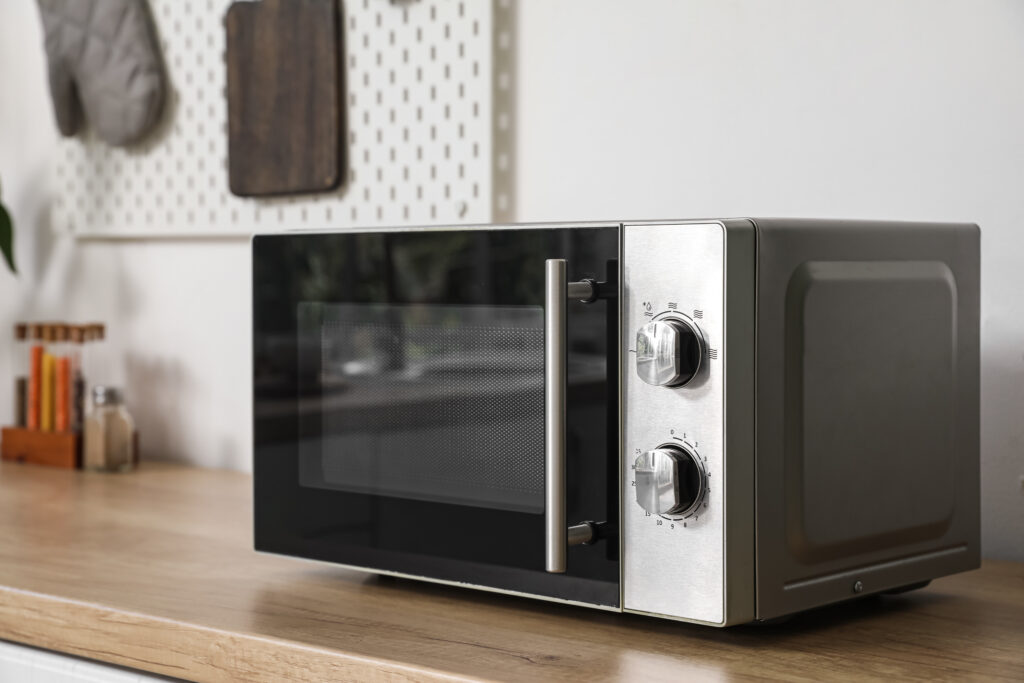 Modern microwave oven on counter in stylish kitchen