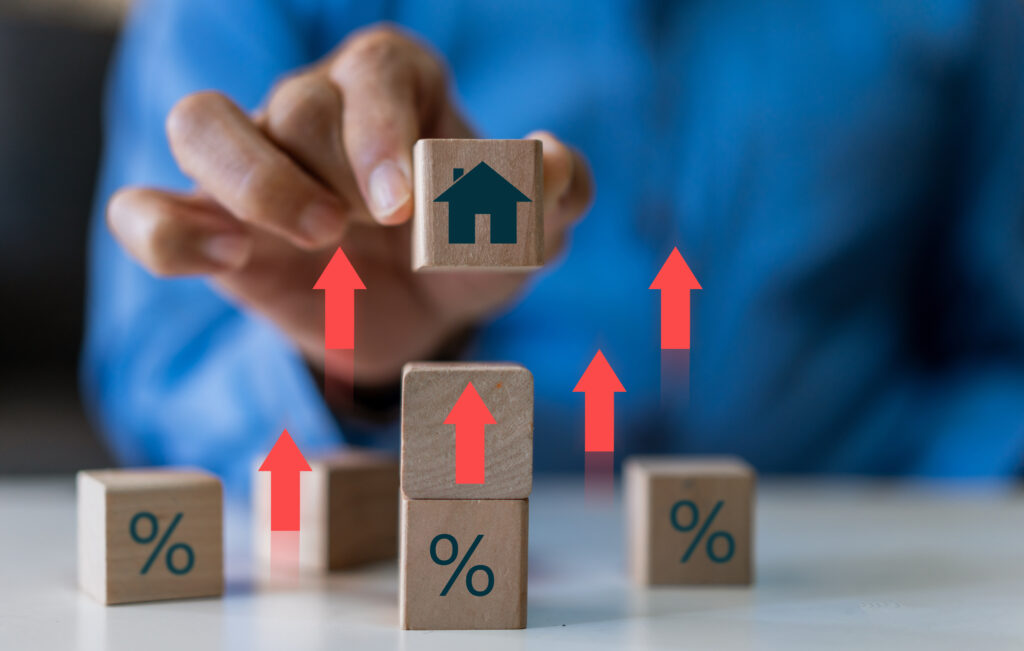 Businessman hold house with percentage, concept of real estate market trends, mortgage rates, property investment and housing market analysis, interest rates and financial planning, home ownership